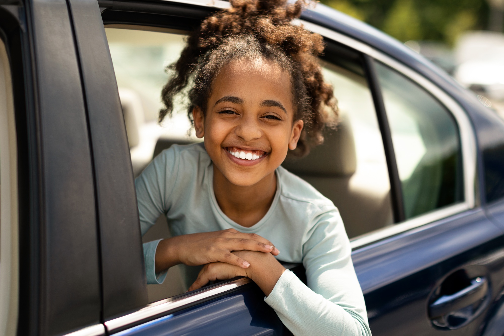 Happy Black Kid Girl Looking Out Of Car Window