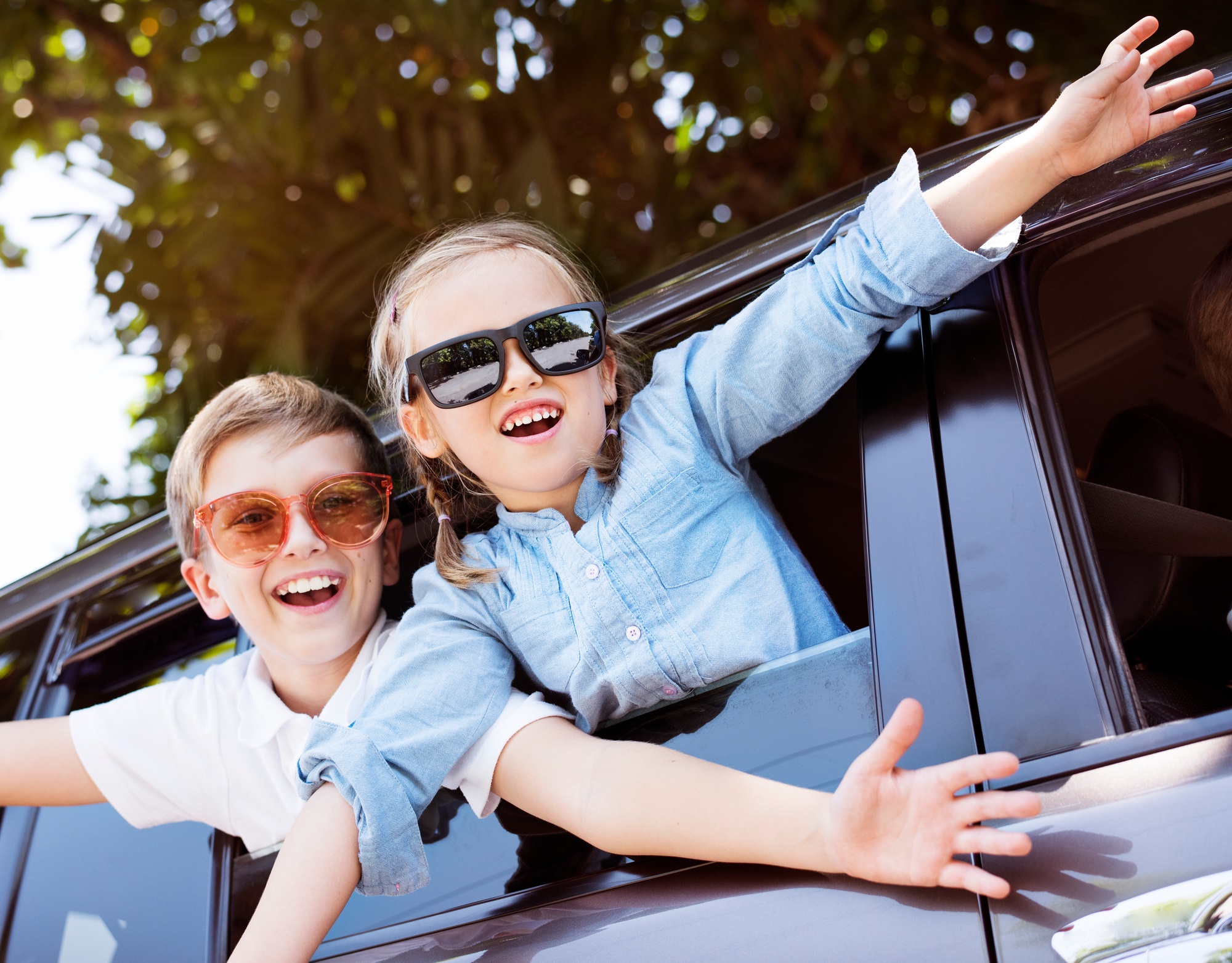 Happy kids looking out the car window