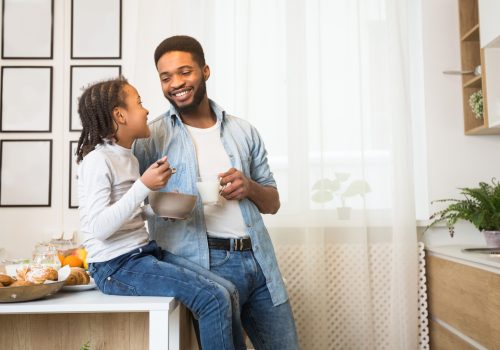 Friendly family having breakfast together in kitchen