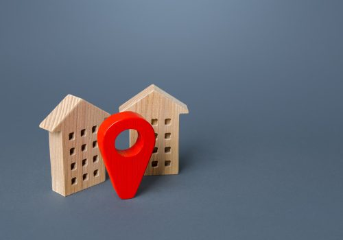 Red location pin and houses. Location concept, settlement. Tracking, internet of things.